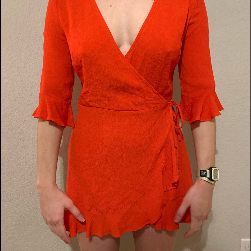Red “wrap” dress with romper style structure. Looks like dress.
